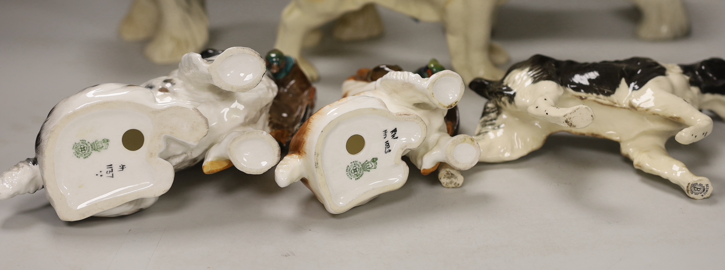 A group of six ceramic models of dogs including Royal Doulton and Beswick